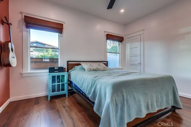 a view of a workspace with furniture and wooden floor