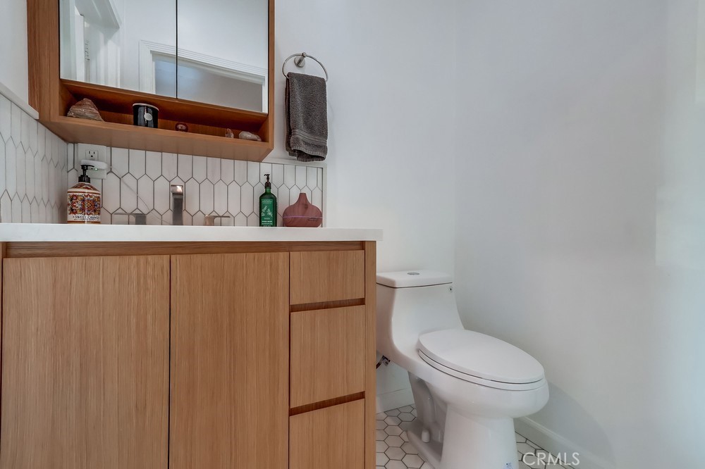 456 Cherry Avenue Long Beach, CA 90802 - Photo 46 of 74 a bathroom with a toilet sink and mirror