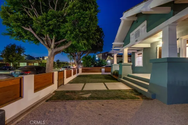a view of a house with a yard and sitting area