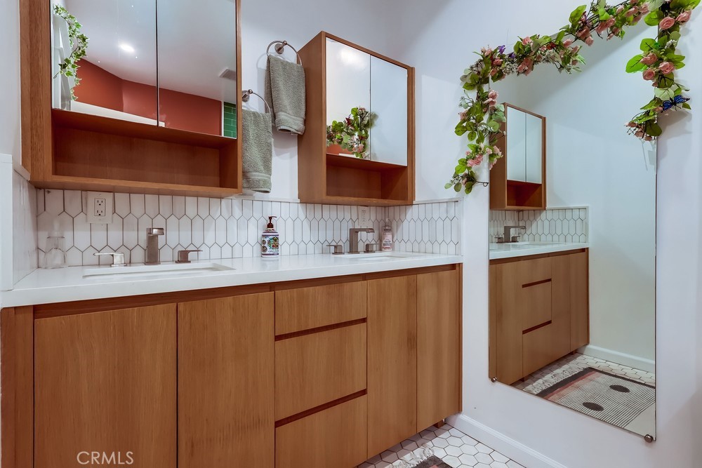 456 Cherry Avenue Long Beach, CA 90802 - Photo 55 of 74 a bathroom with a sink a mirror and a shower