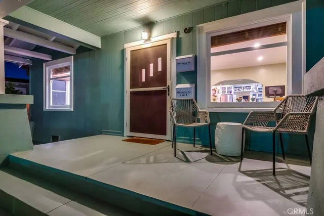 a view of a house with a yard and sitting area