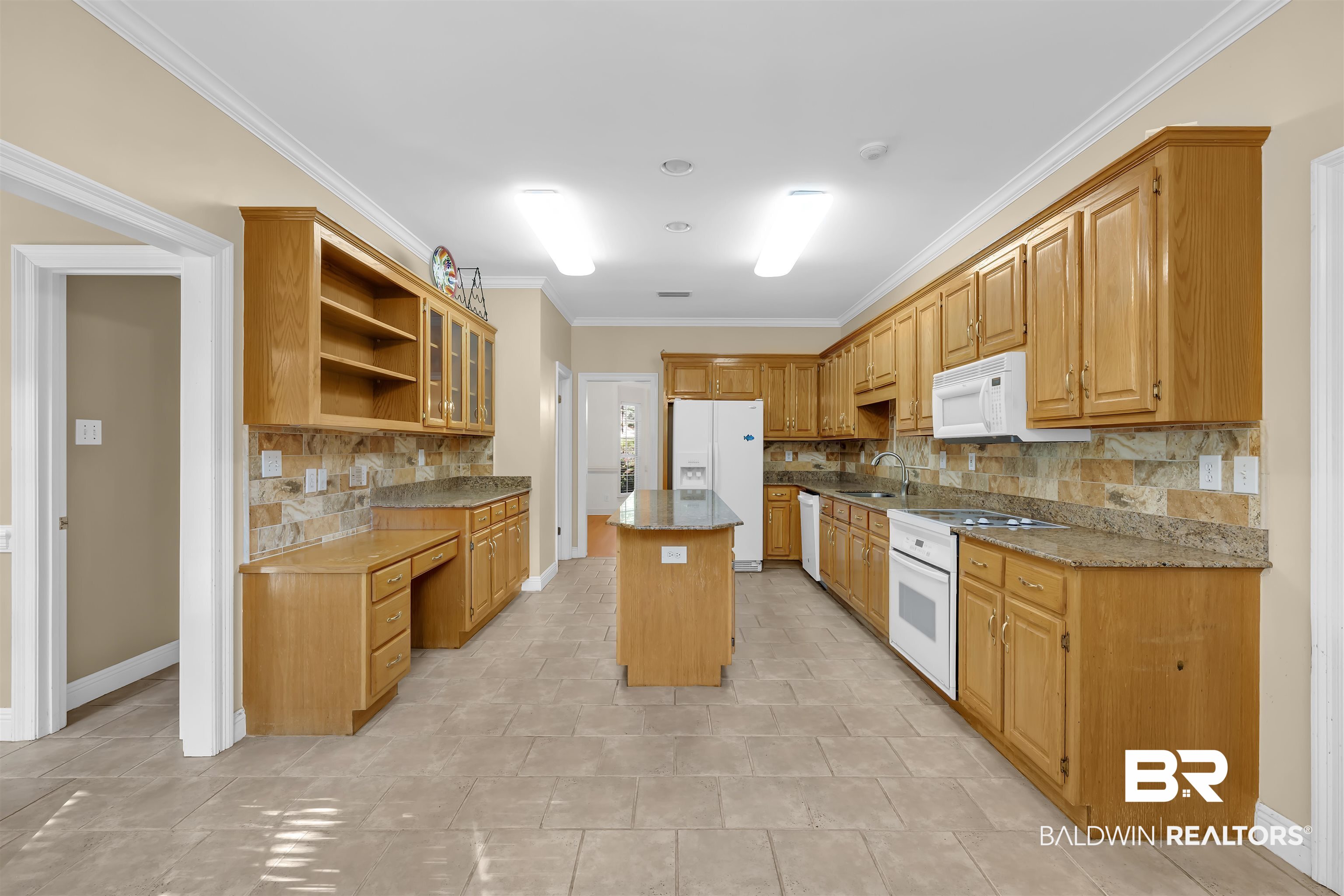 1262 Patrick Street Daphne, AL 36526 - Photo 11 of 35 Kitchen featuring open shelves, white appliances, crown molding, a kitchen island, and decorative backsplash