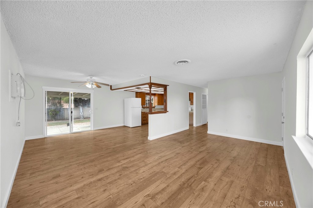 10411 Lexington Street Stanton, CA 90680 - Photo 12 of 30 a view of an empty room with wooden floor and a window