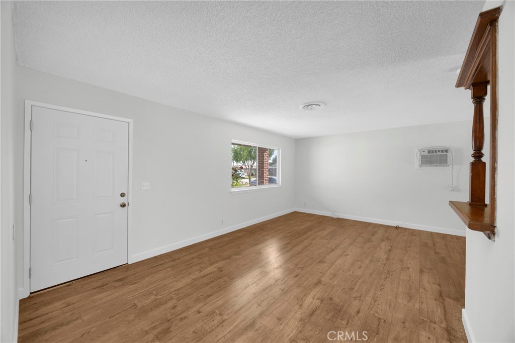 10411 Lexington Street Stanton, CA 90680 - Photo 14 of 30 an empty room with wooden floor and windows