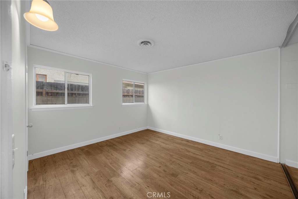10411 Lexington Street Stanton, CA 90680 - Photo 15 of 30 a view of an empty room with window and wooden floor