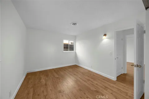 a view of an empty room and wooden floor