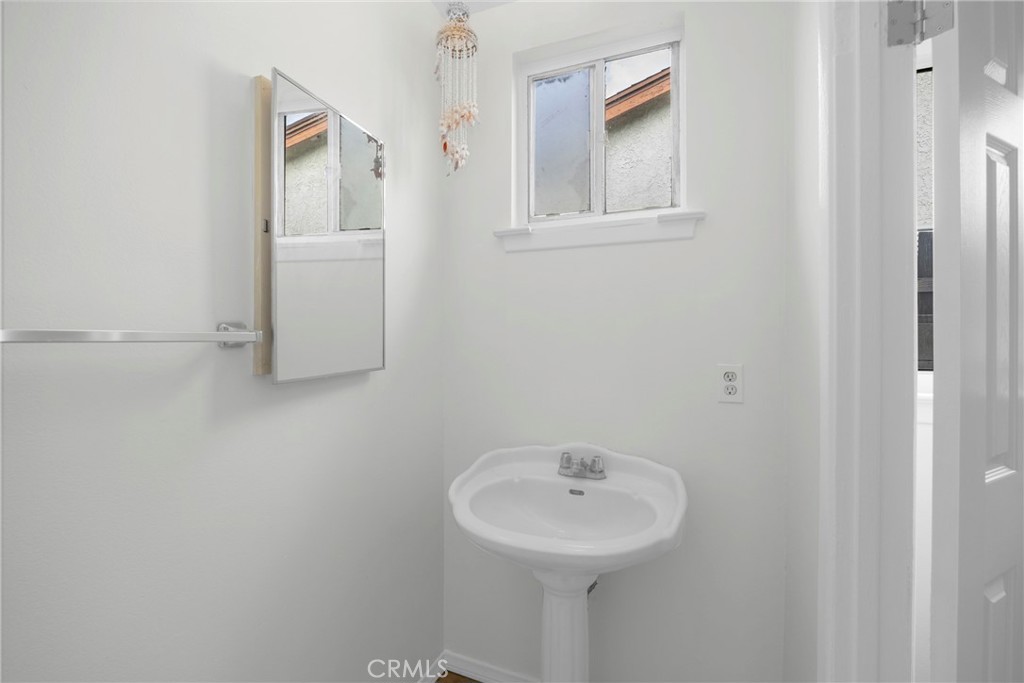 10411 Lexington Street Stanton, CA 90680 - Photo 23 of 30 a bathroom with a sink and a mirror