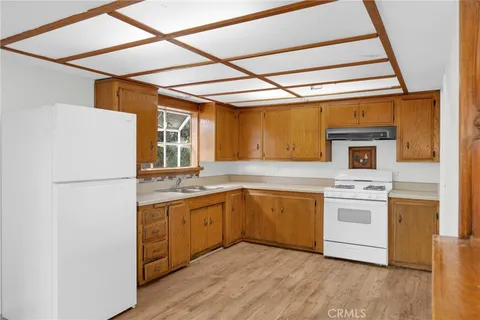 a kitchen with a sink and white cabinets