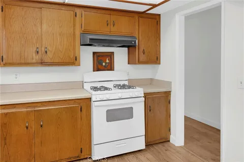 a kitchen with a stove top oven sink and cabinets