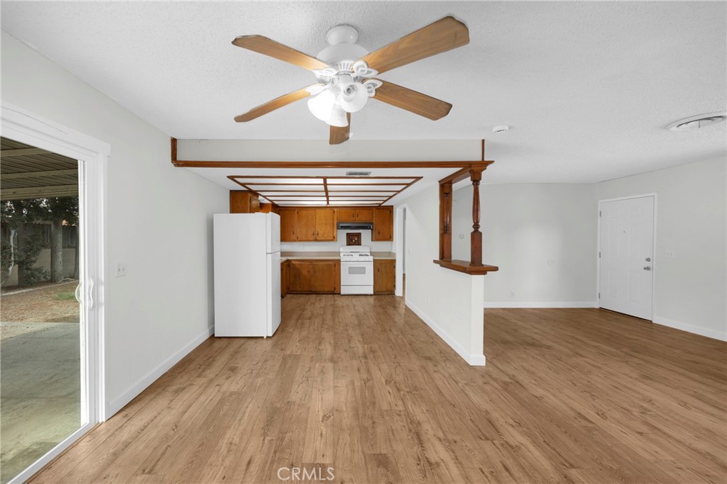 10411 Lexington Street Stanton, CA 90680 - Photo 10 of 30 a view of a hallway with wooden floor and a chandelier