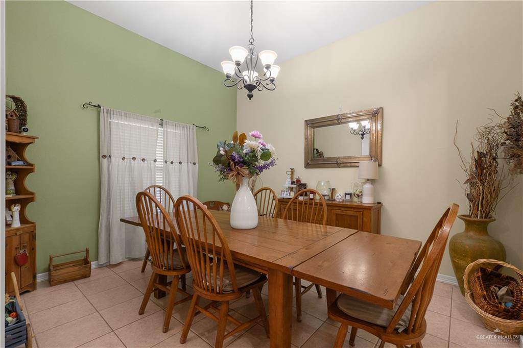 605 South Whalen Road Donna, TX 78537 - Photo 6 of 21 Spacious living area featuring a tray ceiling, ceiling fan, and tile flooring