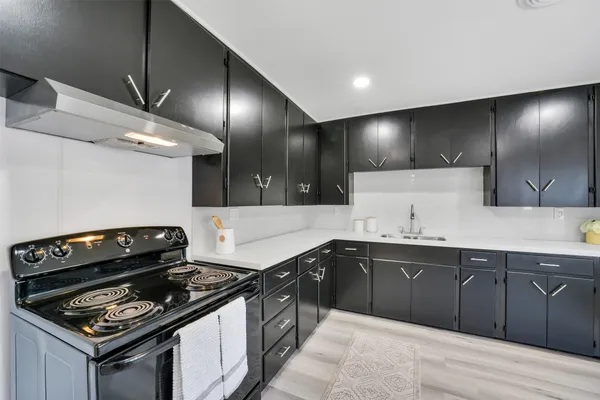 a kitchen with a stove and a sink