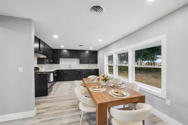 a kitchen with a table and chairs in it