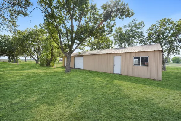 a view of a backyard with large trees