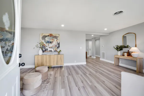 a living room with furniture and a wooden floor