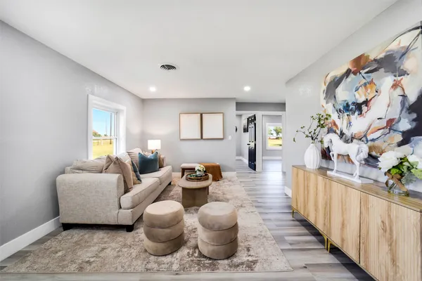 a living room with furniture and flowers