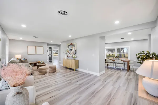 a living room with furniture and wooden floor