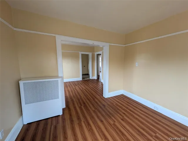 a view of bedroom with wooden floor