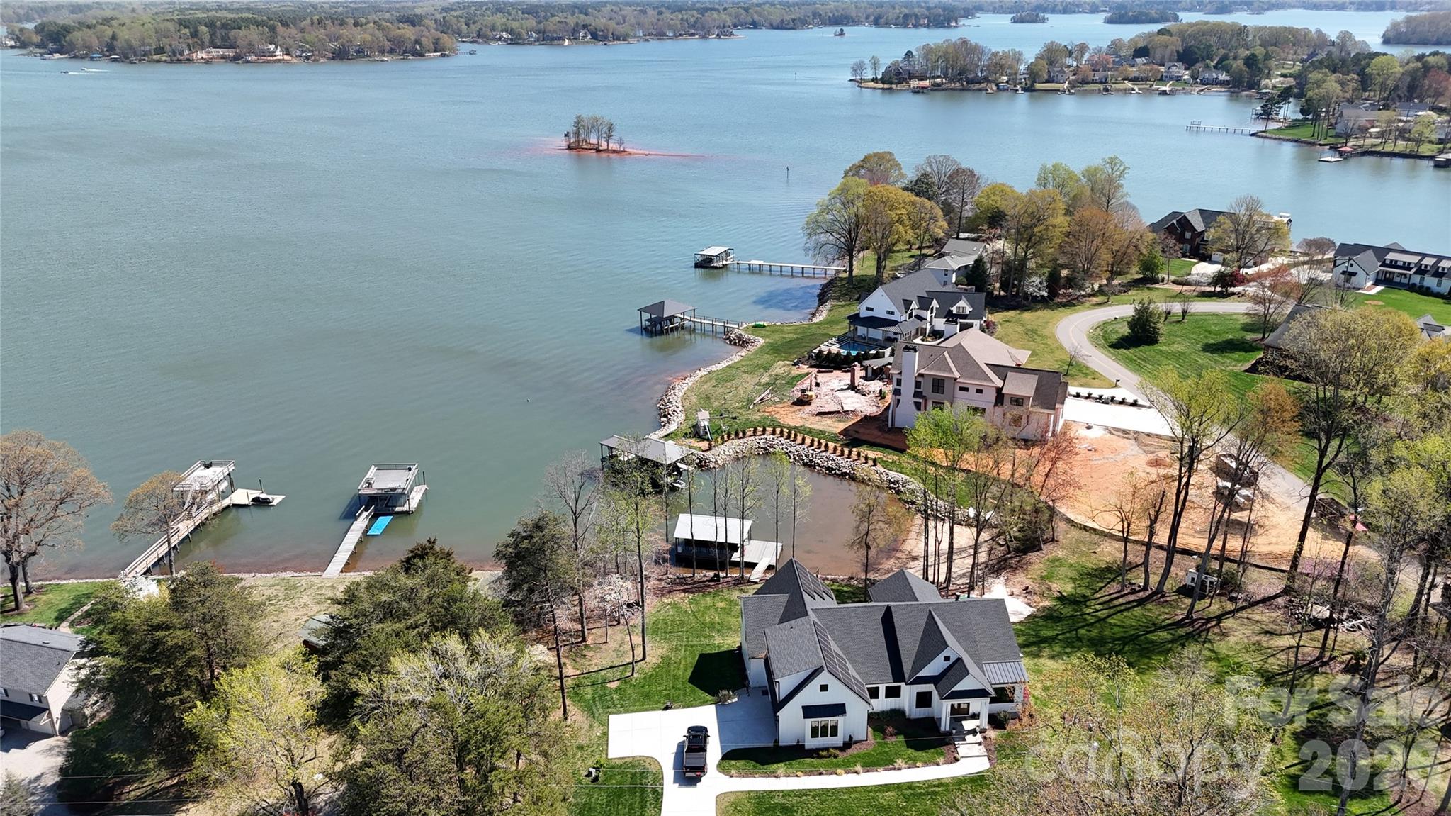5056 Bridge Way Denver, NC 28037 - Photo 4 of 42 an aerial view of a house with a lake and trees all around