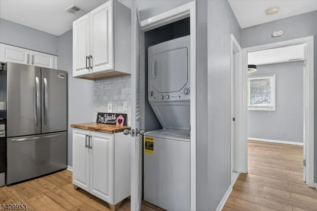a kitchen with refrigerator and cabinets