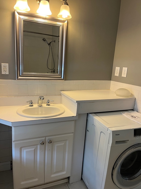 27 Pleasant Street, Unit 1 Middleton, MA 01949 - Photo 15 of 21 a utility room with a sink washer and dryer