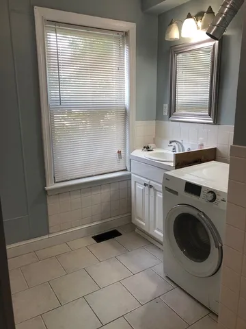 a bathroom with a sink a washer and dryer
