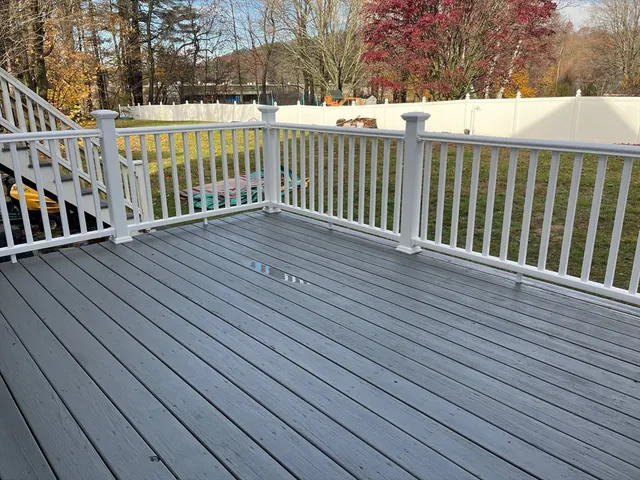 a view of deck with wooden floor and fence