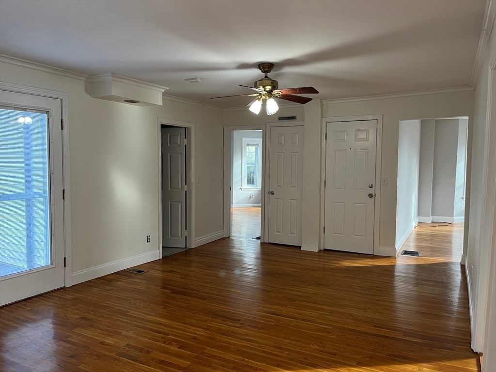 27 Pleasant Street, Unit 1 Middleton, MA 01949 - Photo 4 of 21 a view of empty room with wooden floor