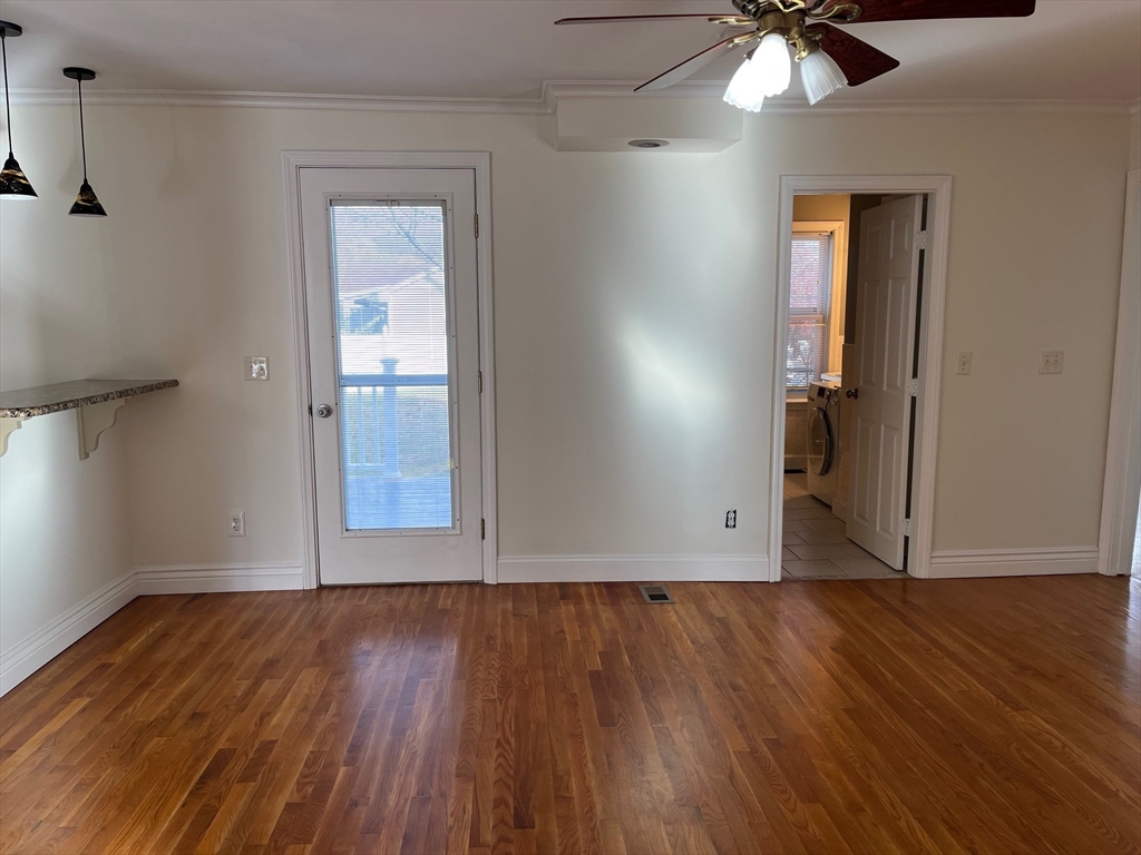 27 Pleasant Street, Unit 1 Middleton, MA 01949 - Photo 10 of 21 an empty room with wooden floor fan and windows