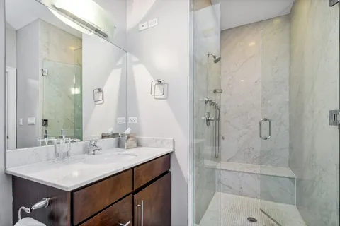 a bathroom with a sink a shower and a mirror