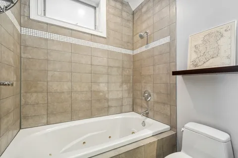 a bathroom with a bathtub and shower
