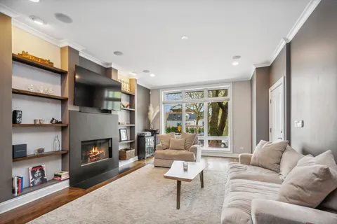 a living room with furniture flat screen tv and a fireplace