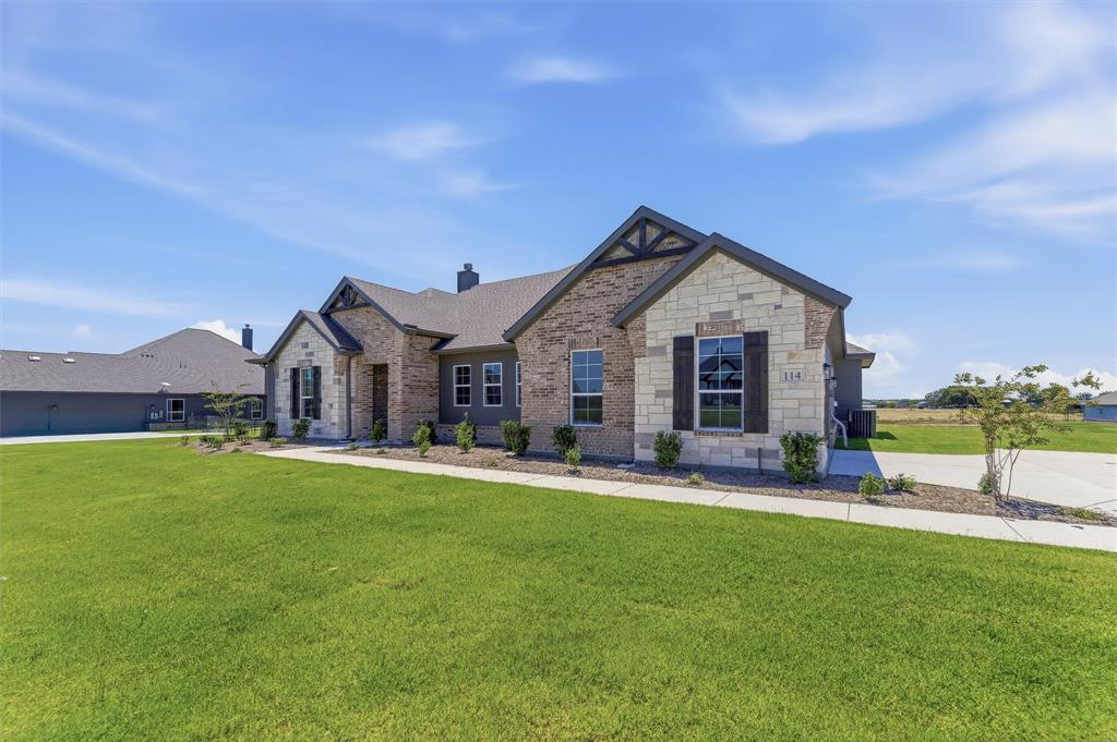 114 Hillview Trail Decatur, TX 76234 - Photo 3 of 27 Crafted stone and brick facade featuring decorative gables and dark window shutters