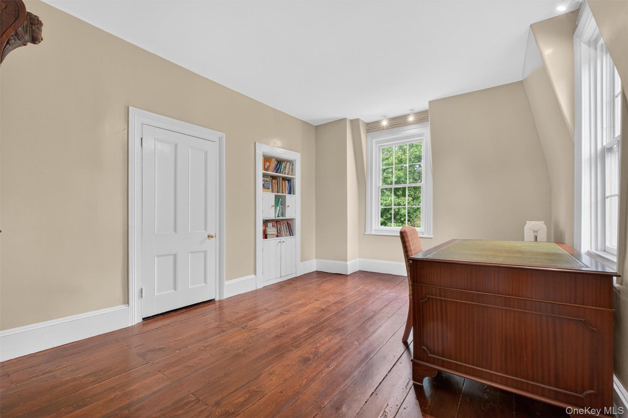 121 Old Glenham Road Fishkill, NY 12524 - Photo 23 of 50 Room featuring wide-plank wood flooring, light-toned walls, white trim,closet, and large windows.