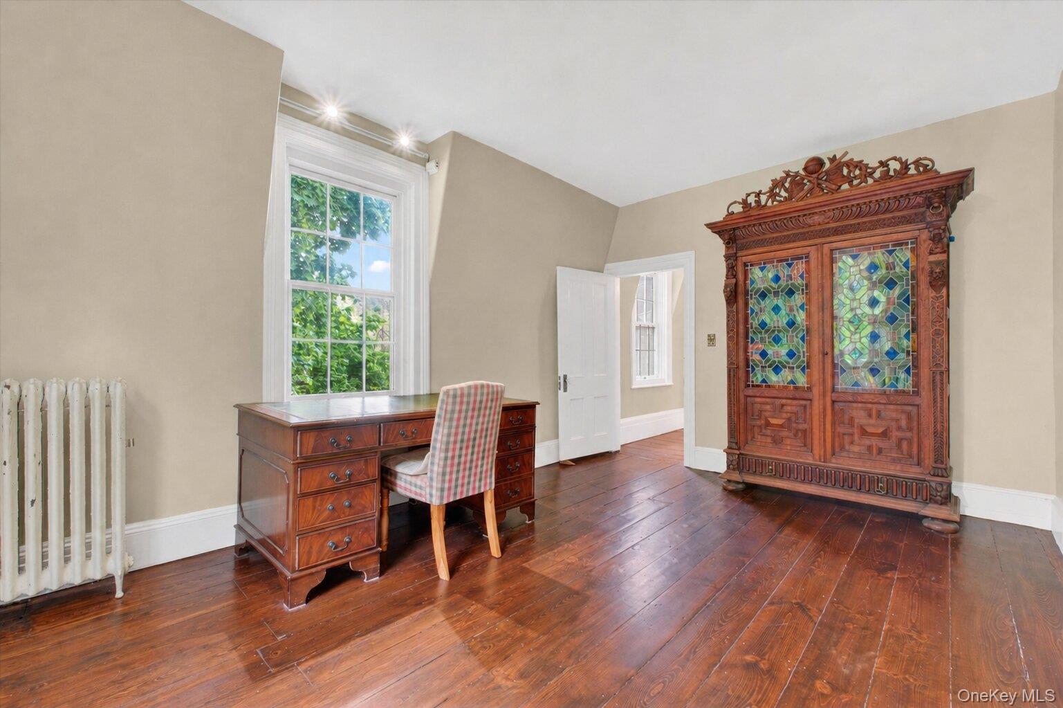 121 Old Glenham Road Fishkill, NY 12524 - Photo 24 of 50 Room featuring wide-plank wood flooring, light-toned walls, white trim,closet, and large windows.
