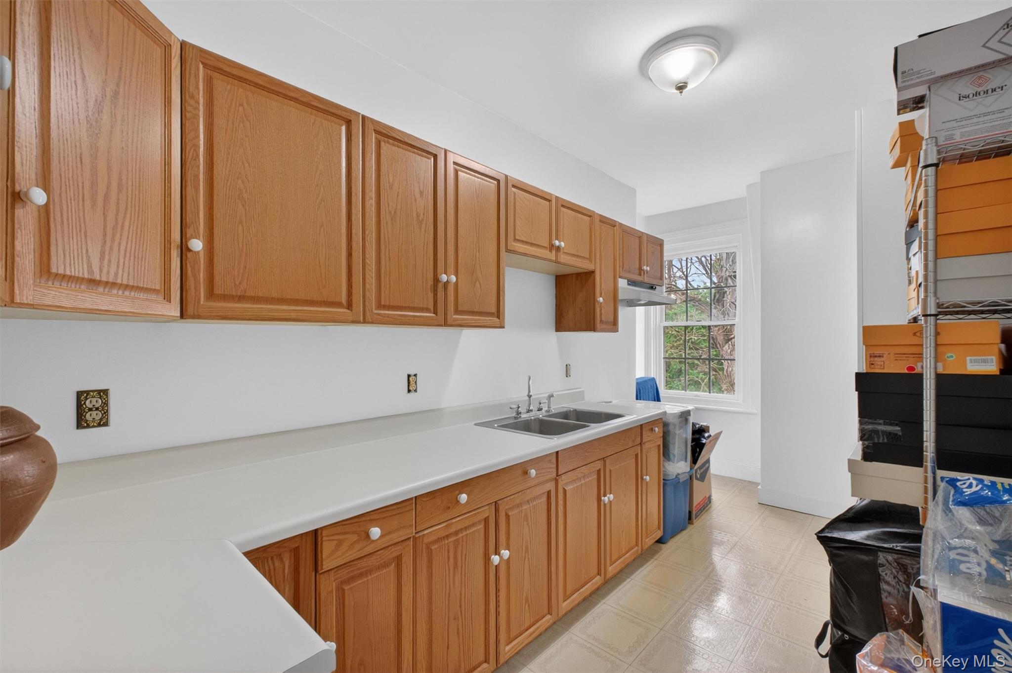 121 Old Glenham Road Fishkill, NY 12524 - Photo 27 of 50 Kitchenette featuring light wood-finish cabinetry, white countertops, and a dual basin stainless steel sink - utilized for the legal accessory apartment/ADU