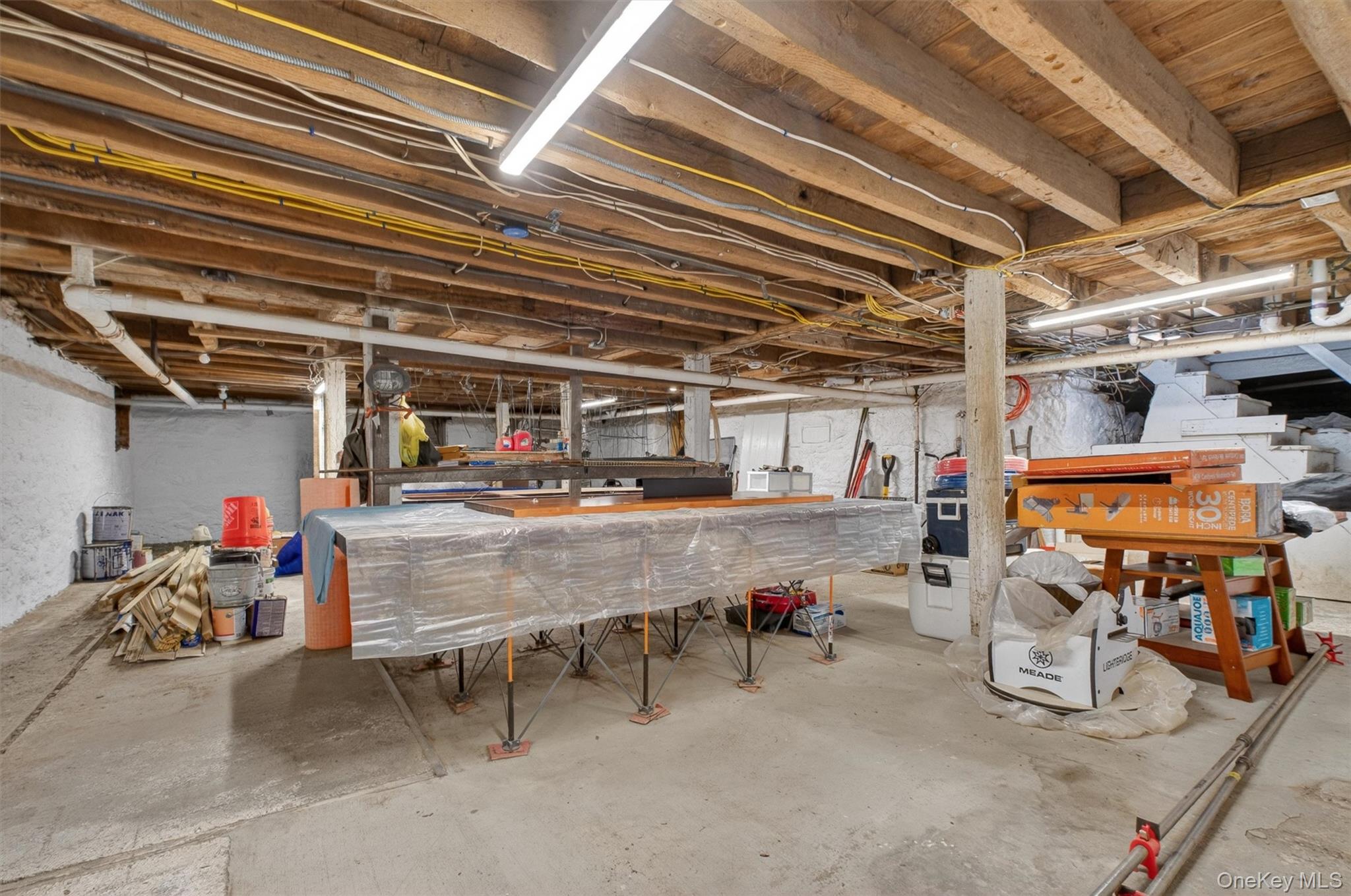 121 Old Glenham Road Fishkill, NY 12524 - Photo 38 of 50 Spacious basement featuring exposed wood ceiling joists and concrete flooring with access to outdoors.