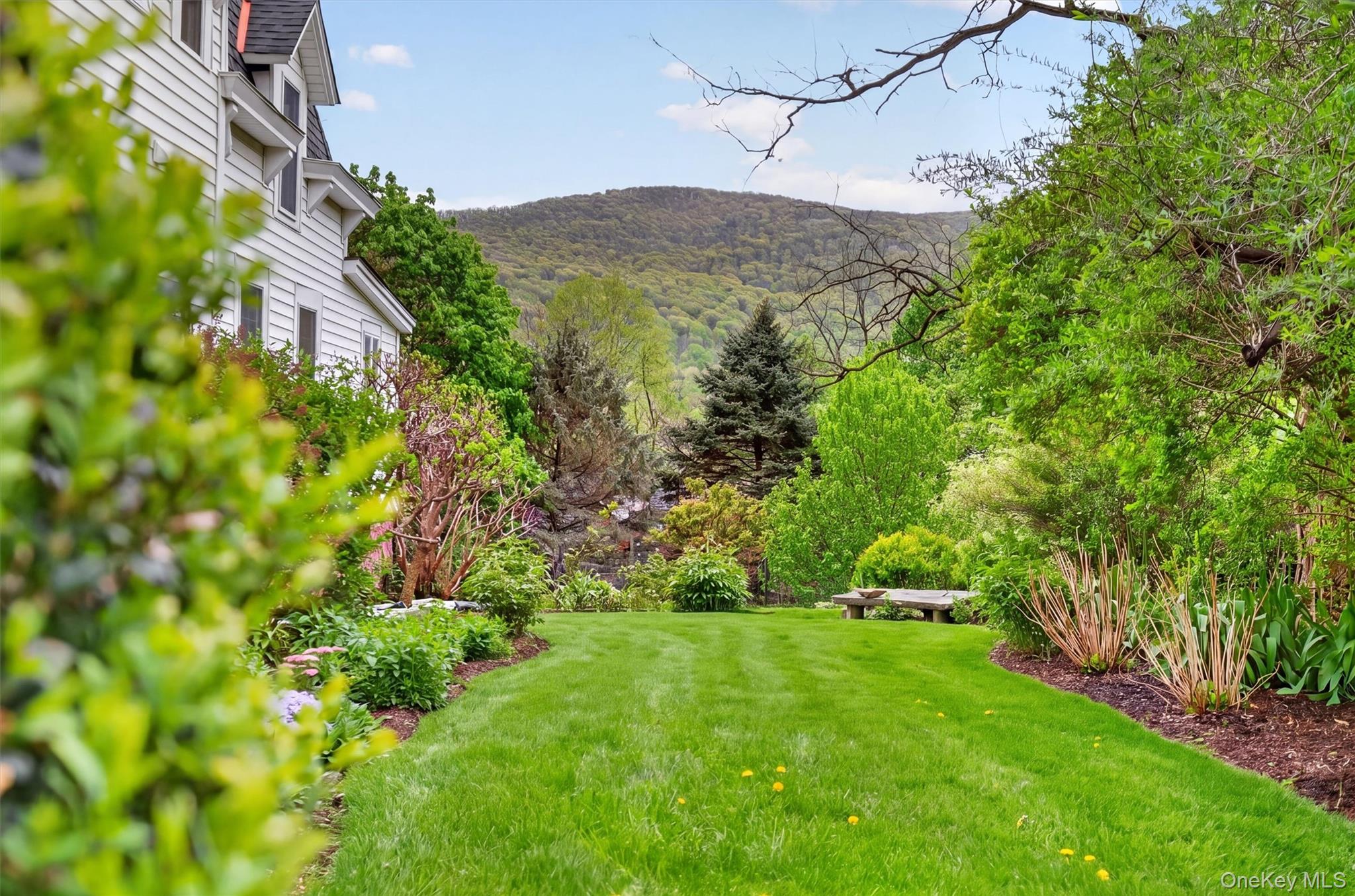 121 Old Glenham Road Fishkill, NY 12524 - Photo 49 of 50 Expansive green lawn framed by manicured hedges leading to the backyard with views of the hills and mountain.