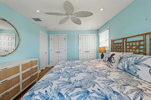 a bedroom with a large bed and a chandelier