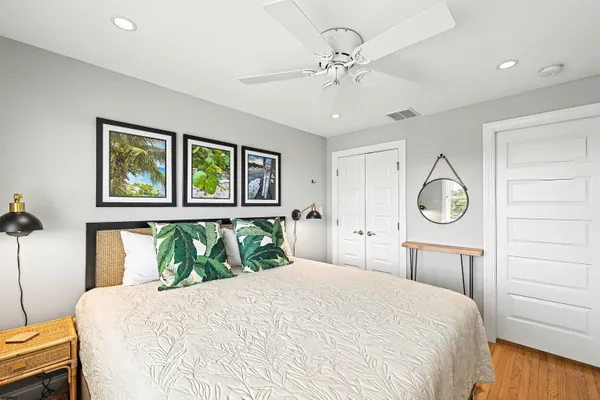 a bedroom with a large bed and a chandelier