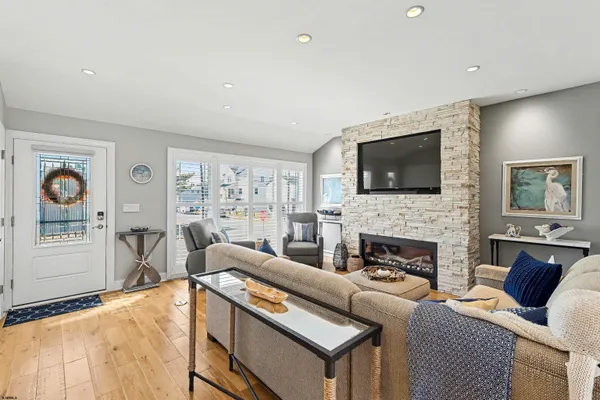 a living room with furniture fireplace and flat screen tv
