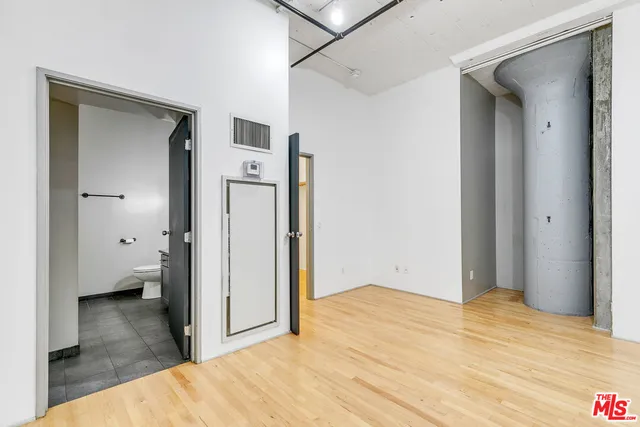 a view of a room with closet and wooden floor