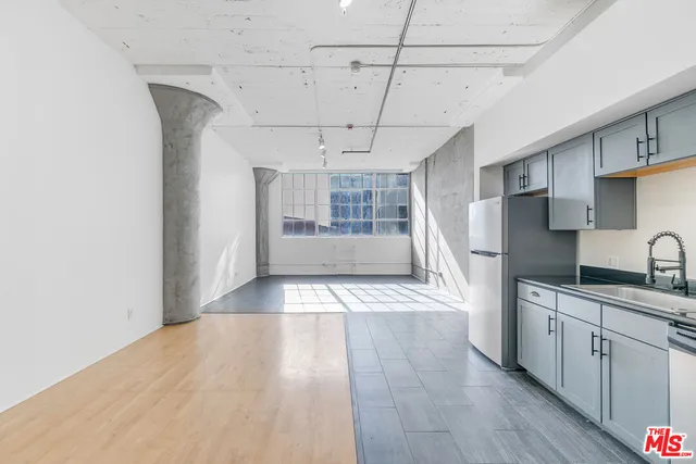 a view of a kitchen with a sink and cabinets