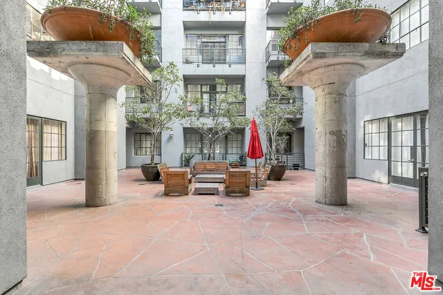 a view of a building with sitting area and garden