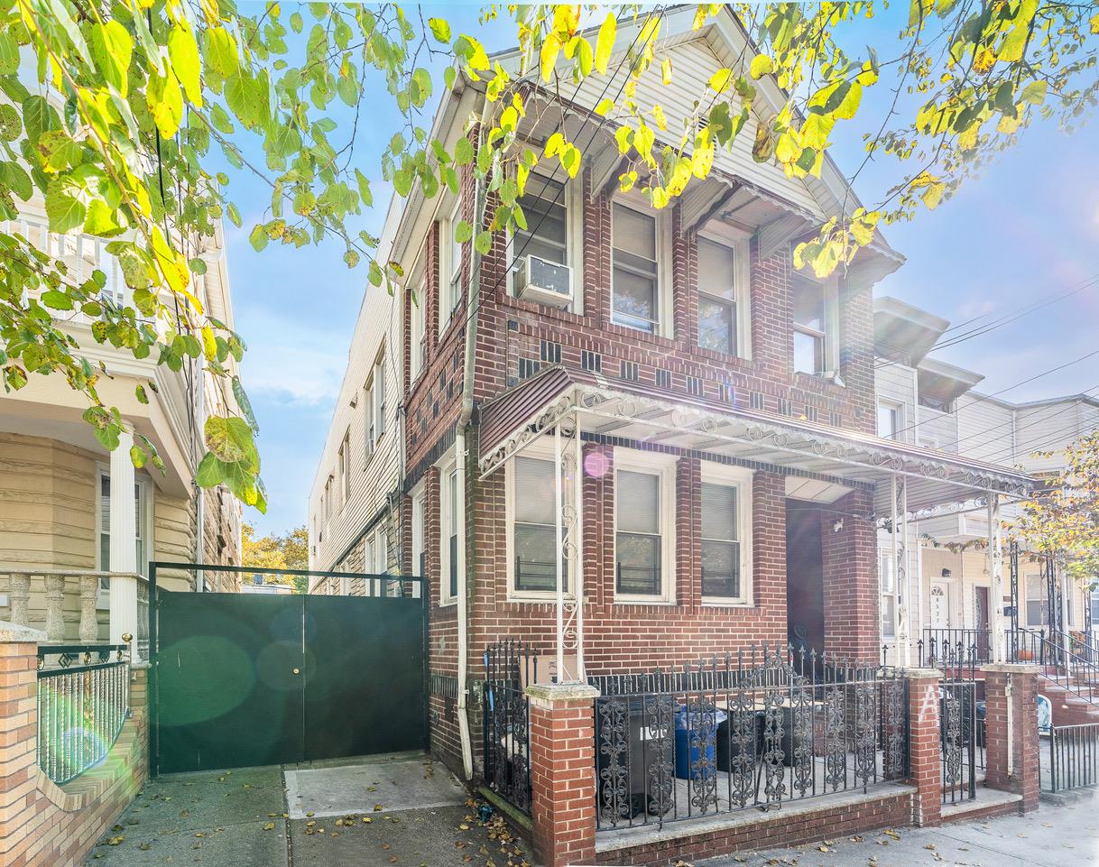 85-23 79th Street Queens, NY 11421 - Photo 1 of 1 a front view of a building with a tree