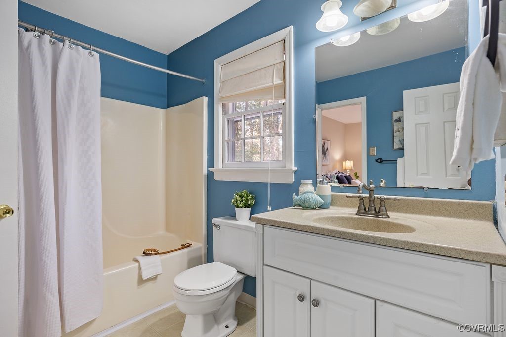 5803 Mill Spring Road Midlothian, VA 23112 - Photo 18 of 48 a bathroom with a sink a toilet and a mirror
