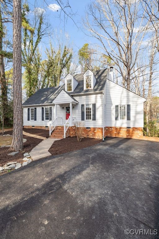 5803 Mill Spring Road Midlothian, VA 23112 - Photo 46 of 48 a view of a white house with a large windows and a yard with of a house