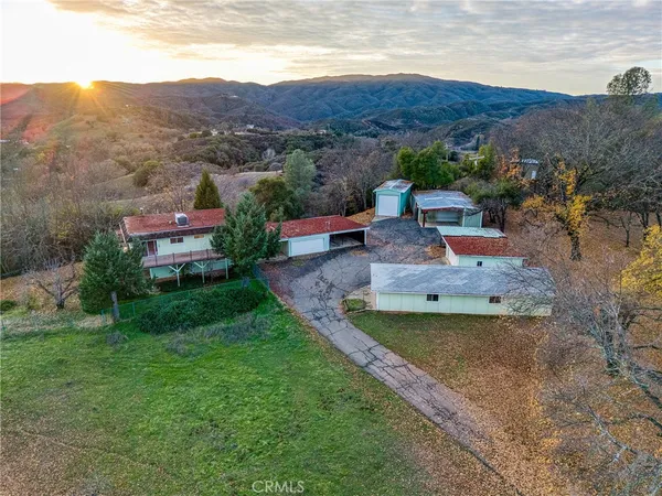 a view of a house with a mountain in the background