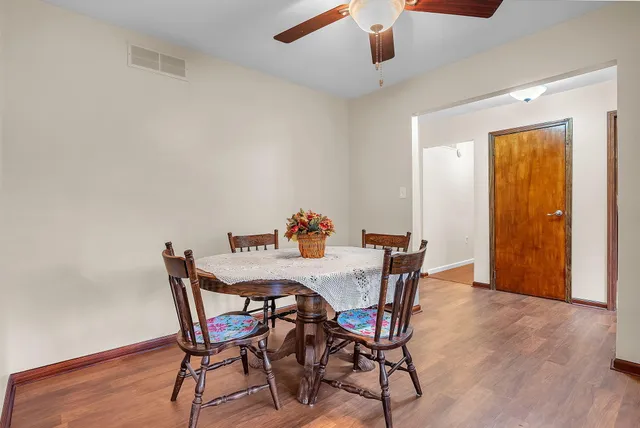 a bedroom with a bed a dresser and flat screen tv
