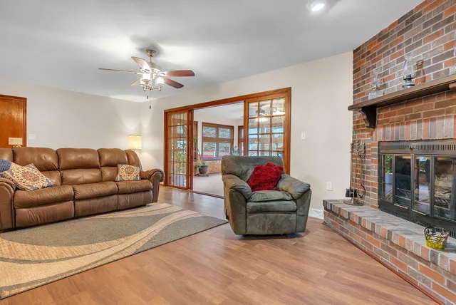 a living room with furniture a fireplace and a flat screen tv